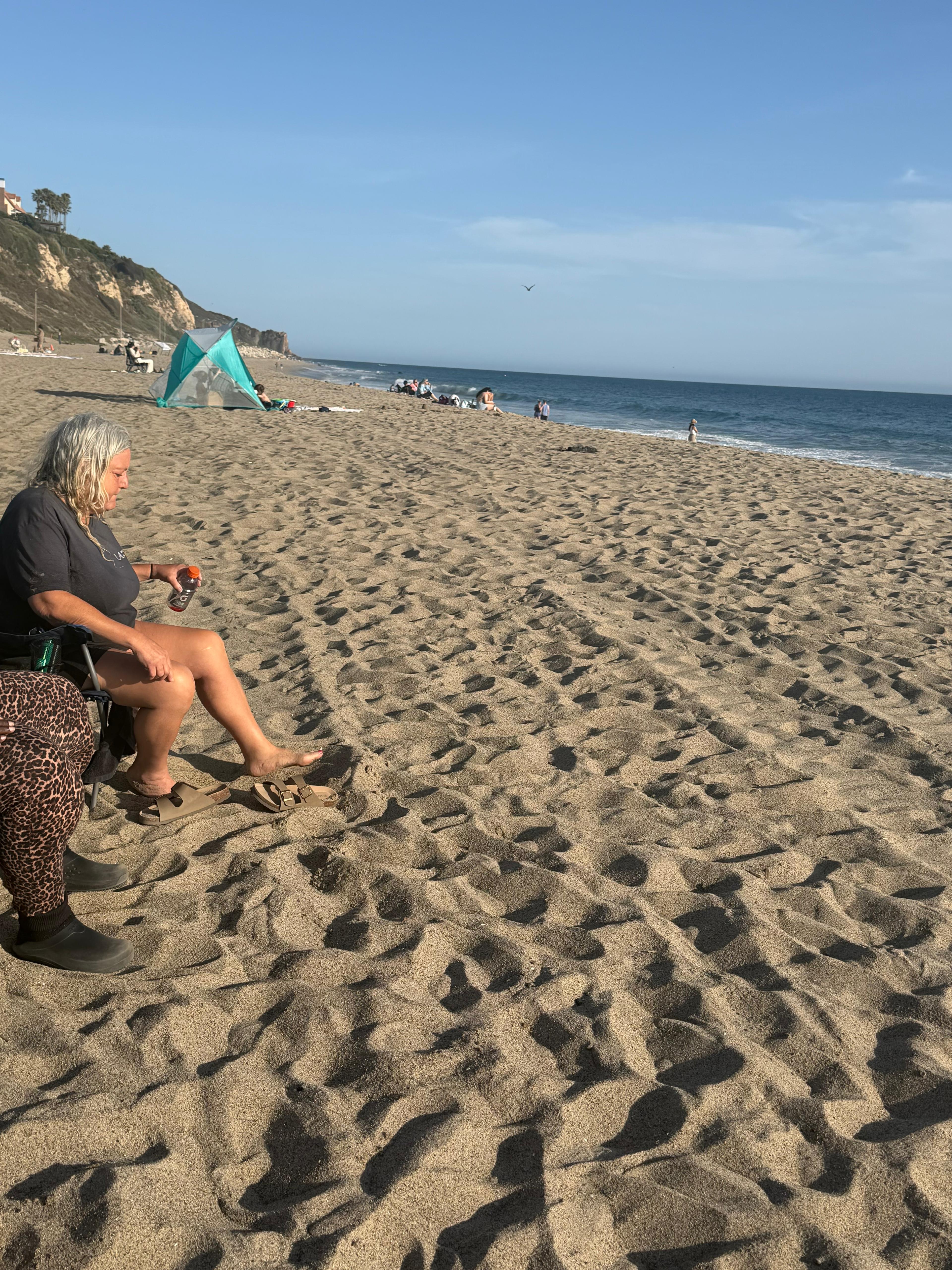 Relaxing at the beach during a supervised Wellness Haven outing in Los Angeles